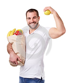 Happy man with paper bag full of vegetables