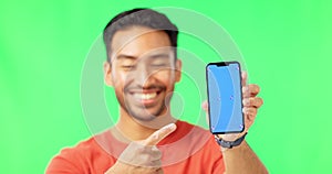 Happy man, phone and pointing to mockup on green screen with tracking markers against a studio background. Portrait of