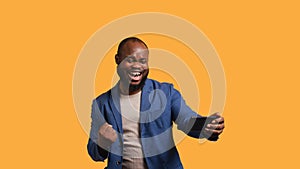 Happy man playing videogames on smartphone, celebrating, studio background photo