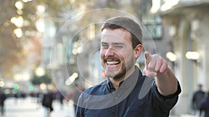 Happy man pointing at camera smiling