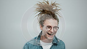 Happy man posing on grey background. Closeup guy laughing at camera