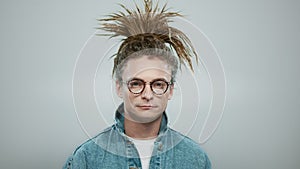 Happy man posing on grey background. Closeup stylish guy laughing at camera