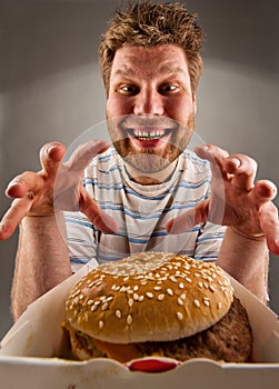 Feliz hombre preparación sobre el comer hamburguesa 