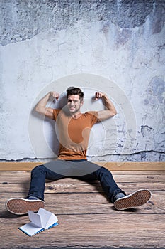 Happy man presenting his muscles