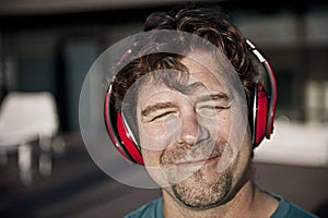 Happy man in red headphones