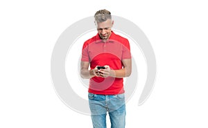 happy man in red tshirt messaging on smartphone isolated on white background