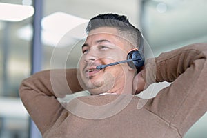 Happy man, relax and call centre with headphone for customer service, support and telemarketing in office. Male employee