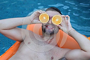 Happy man relaxing in swimming pool