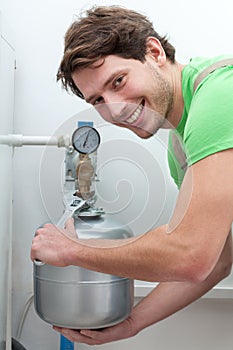 Happy man repairing boiler