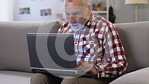 Happy man rising his hands up reading email about hiring, job for pensioners