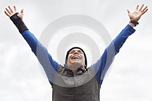 Happy man, runner or hands up for success in training adventure, exercise or workout victory. Excited, sky or healthy