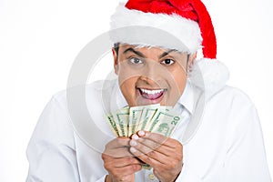 Happy man in santa claus hat holding money