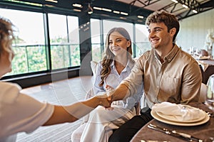 happy man shaking hands with event