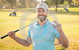 happy man showing ball of golf game on green grass, golf