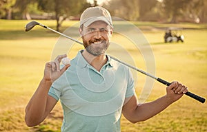 happy man showing ball of golf game on green grass, golf