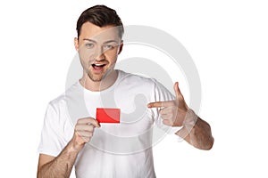 Happy man showing by finger on blank card
