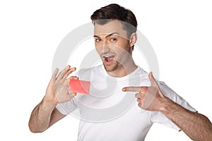 Happy man showing by finger on blank card