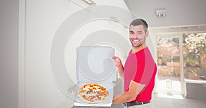 Happy man showing pizza in box