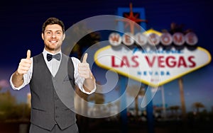 Happy man showing thumbs up over las vegas sign
