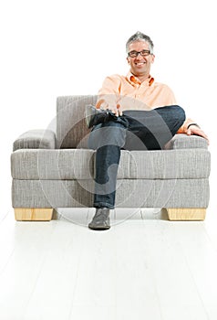 Happy man sitting on couch photo