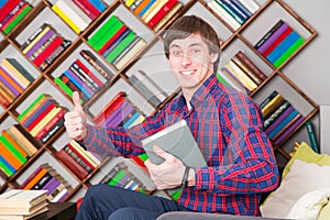 Happy man sitting and holding book