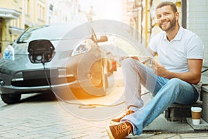 Happy man sitting with a map and smiling