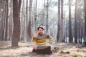 Happy man sitting outdoors using a laptop computer