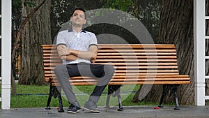 Happy Man Sitting On Park Bench