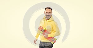 happy man skateboarder with beard hold penny skateboard  on white, hipster lifestyle.