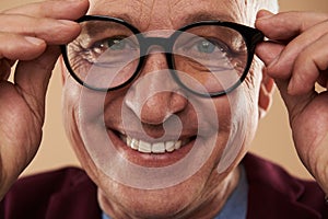 Happy man smiling with his white teeth while wearing glasses