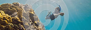 Happy man in snorkeling mask dive underwater with tropical fishes in coral reef sea pool. Travel lifestyle, water sport