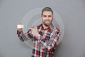 Happy man standing with copyspace business card