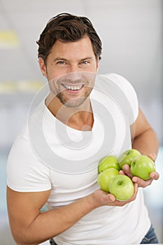 happy man standing and holding apples in hands