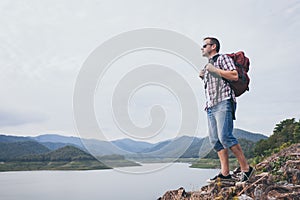 Happy man standing near the lake at the day time