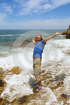 Happy man stands in foamy wave