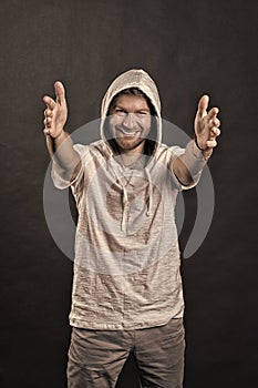 Happy man with stretched hands. Bearded man with beard wear hood. Fashion model smile in hoodie tshirt. Active lifestyle