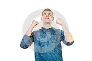 Happy man successful with arms up clenching fist