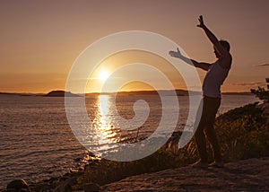 Happy man in sunset by the sea.