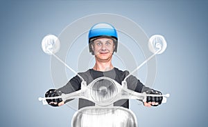 Happy man in a t-shirt and motorcycle helmet rides an imaginary motor scooter, on a blue background. Front view.