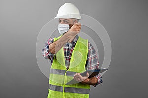 Happy man taking off medical mask. Handman worker after quarantine