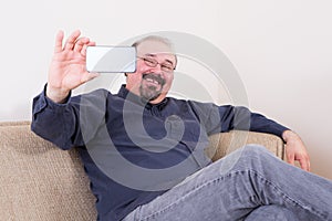 Happy man taking a selfie for his friends