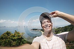 Happy man taking selfie photo from summer vacation