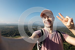 Happy man taking selfie photo from summer vacation day