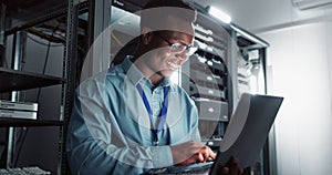 Happy man, technician and laptop in server room for database update, cyber security or code. Computer, smile and African