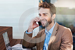 Happy man, technology and phone call in coffee shop for talk, online working, and networking. Laptop, male person and