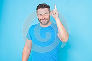 Happy man thinking of idea on studio background. Portrait of man has many ideas. Man with index fingers hand gesture man