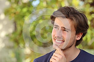 Happy man thinking outdoor