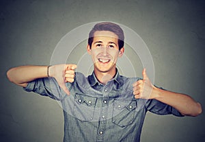 Happy man with thumbs down thumbs up gesture