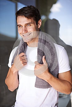 Happy man, towel and hygiene with satisfaction for grooming or morning freshness by window at home. Handsome, young male