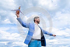happy man with toy plane. business success. successful man in suit dreaming.
